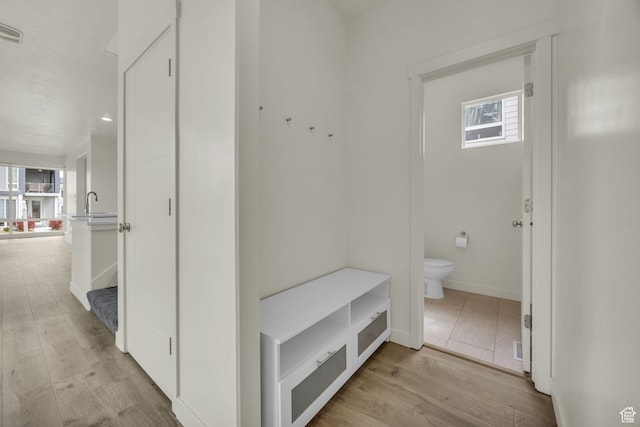 4751 W Vermillion Dr, South Jordan, UT 84009 - mudroom with plenty of natural light, light wood finished floors, a sink, and baseboards