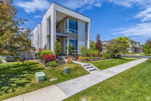 4751 W Vermillion Dr, South Jordan, UT 84009 - contemporary house featuring a front lawn and stucco siding