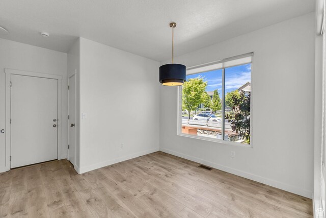 4751 W Vermillion Dr, South Jordan, UT 84009 - unfurnished dining area featuring light wood-style flooring and baseboards