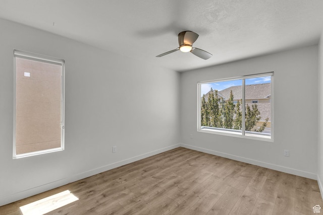 4751 W Vermillion Dr, South Jordan, UT 84009 - spare room featuring light wood-type flooring, ceiling fan, and baseboards