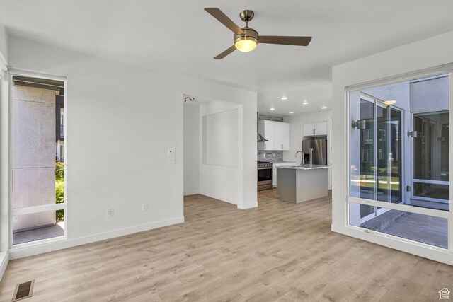 4751 W Vermillion Dr, South Jordan, UT 84009 - unfurnished living room with light wood-style flooring, a ceiling fan, baseboards, and recessed lighting