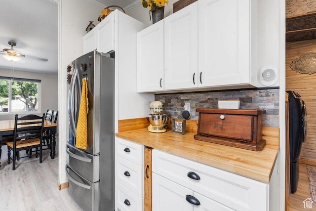 706 E Cottontail Rd, Central, UT 84722 - kitchen with light wood-style floors, wood counters, freestanding refrigerator, and white cabinets