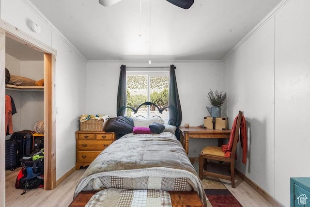 706 E Cottontail Rd, Central, UT 84722 - bedroom with baseboards, light wood-type flooring, a closet, ornamental molding, and a spacious closet