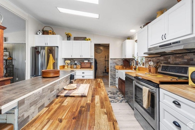 706 E Cottontail Rd, Central, UT 84722 - kitchen with butcher block countertops, light wood-type flooring, under cabinet range hood, lofted ceiling, and stainless steel appliances