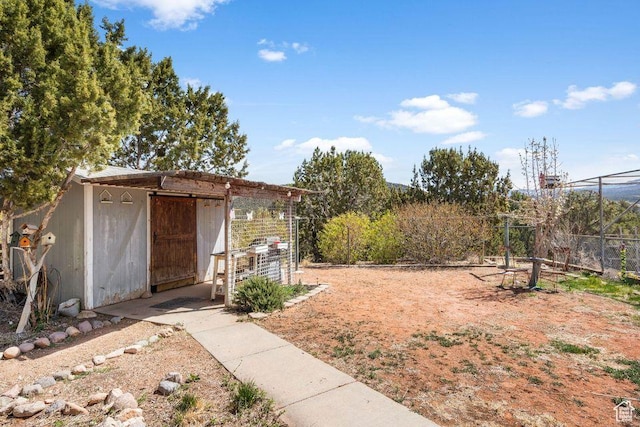 706 E Cottontail Rd, Central, UT 84722 - view of yard featuring fence, an outdoor structure, and a storage unit