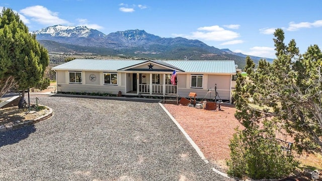 706 E Cottontail Rd, Central, UT 84722 - ranch-style house featuring a porch, metal roof, and a mountain view
