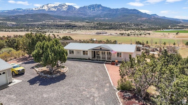 view of front of property featuring a mountain view, covered porch, and driveway