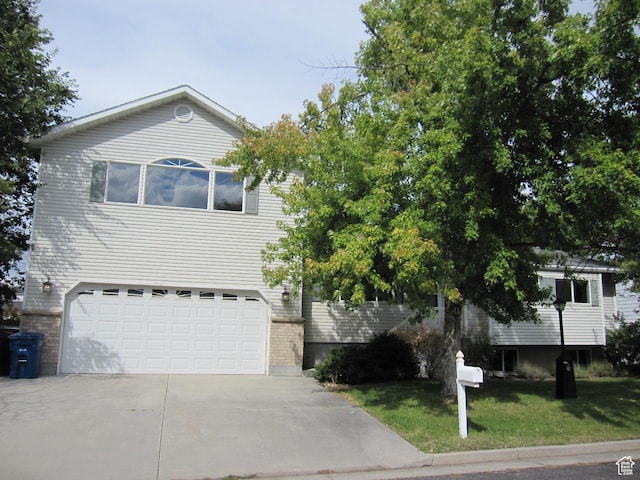 45 River Circle Dr, Logan, UT 84321 - view of front facade featuring a front yard, an attached garage, and driveway