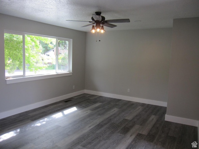 45 River Circle Dr, Logan, UT 84321 - spare room featuring a textured ceiling, dark wood finished floors, baseboards, and a ceiling fan