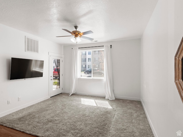 3679 W 1530 N Unit 102, Lehi, UT 84043 - unfurnished living room featuring baseboards, a textured ceiling, visible vents, ceiling fan, and carpet
