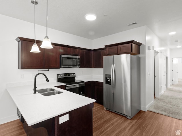 3679 W 1530 N Unit 102, Lehi, UT 84043 - kitchen featuring visible vents, a sink, light countertops, appliances with stainless steel finishes, and a peninsula