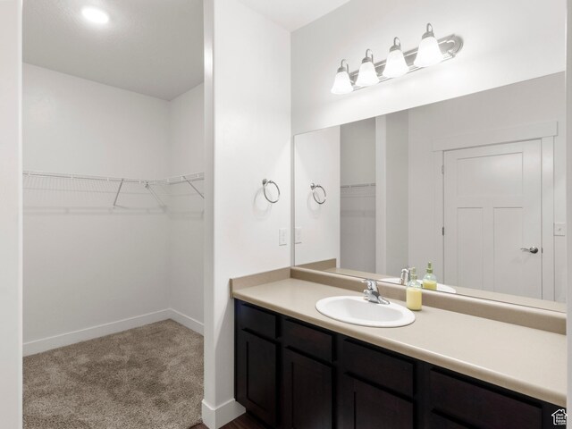 3679 W 1530 N Unit 102, Lehi, UT 84043 - bathroom with vanity, baseboards, and a spacious closet