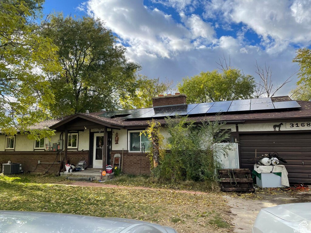 3168 W N Pln, City Road, Plain City, UT 84404 - ranch-style home with a chimney, central AC, solar panels, brick siding, and a garage