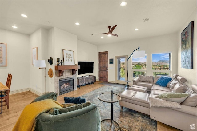 living room with wood finished floors, visible vents, and recessed lighting