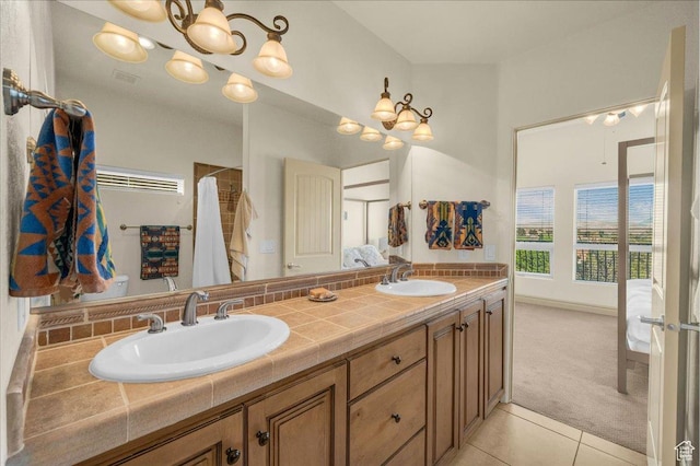 full bathroom featuring tile patterned floors, double vanity, visible vents, and a sink