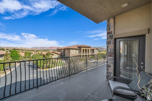 balcony featuring a residential view and a mountain view