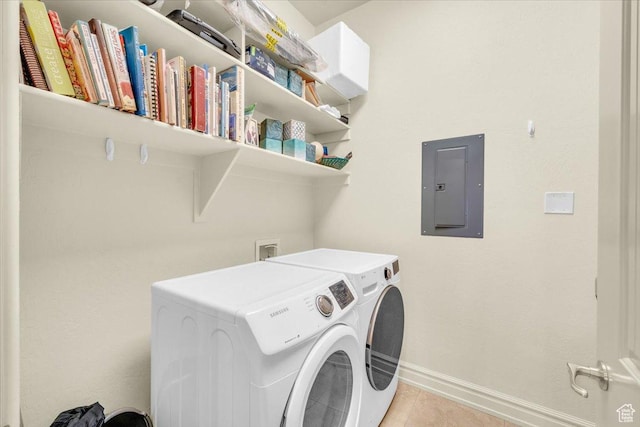 laundry area featuring light tile patterned floors, baseboards, electric panel, laundry area, and washing machine and clothes dryer