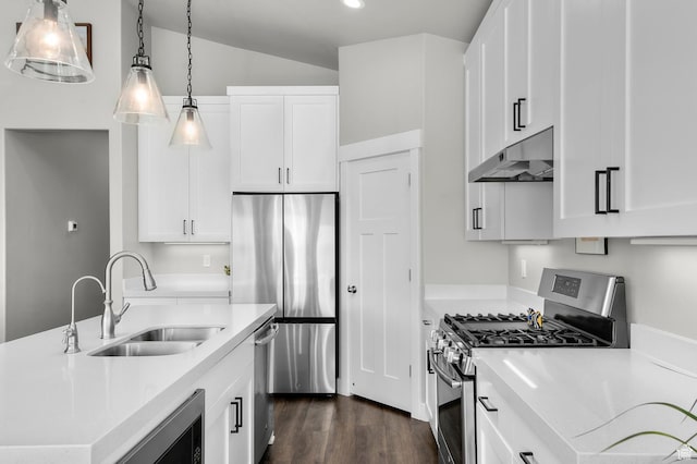 kitchen with a sink, dark wood-style floors, under cabinet range hood, white cabinetry, and stainless steel appliances