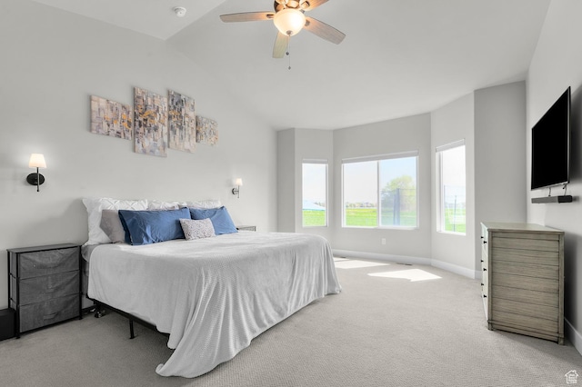 bedroom with ceiling fan, carpet flooring, baseboards, and lofted ceiling