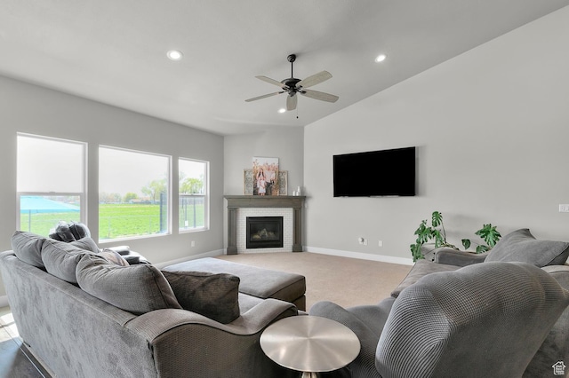 living room with a glass covered fireplace, baseboards, recessed lighting, carpet flooring, and ceiling fan