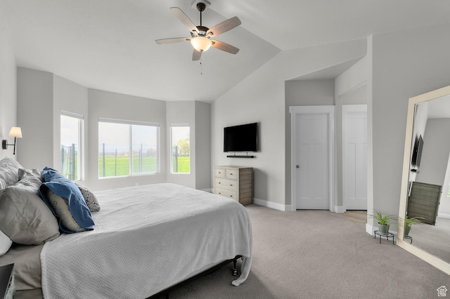 bedroom with light carpet, ceiling fan, baseboards, and lofted ceiling