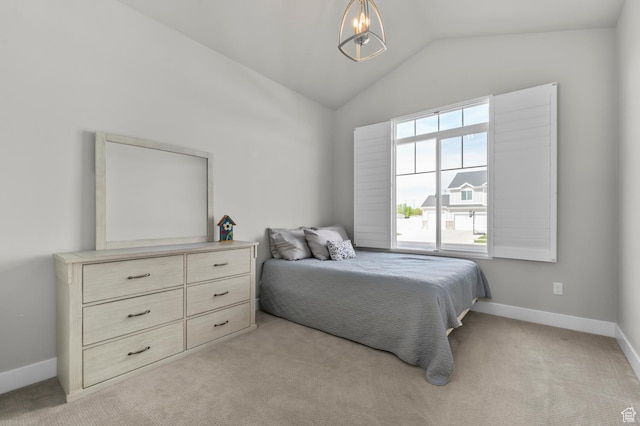 bedroom with light carpet, a notable chandelier, baseboards, and vaulted ceiling