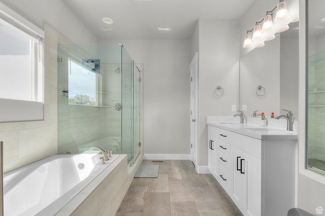 bathroom with a sink, a bath, double vanity, and a shower stall