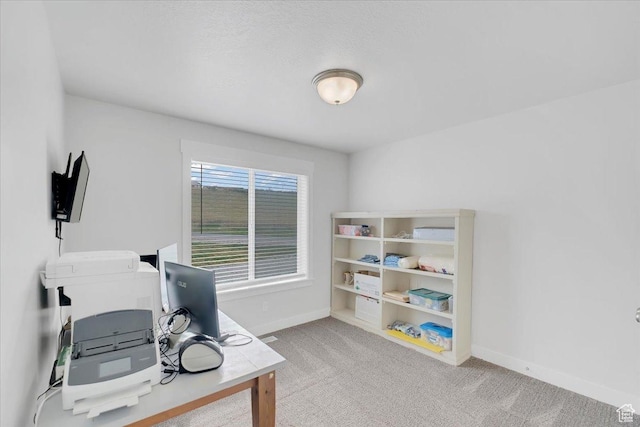 home office featuring baseboards and carpet floors