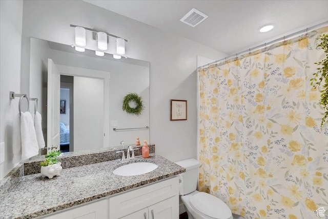 bathroom featuring vanity, visible vents, curtained shower, and toilet