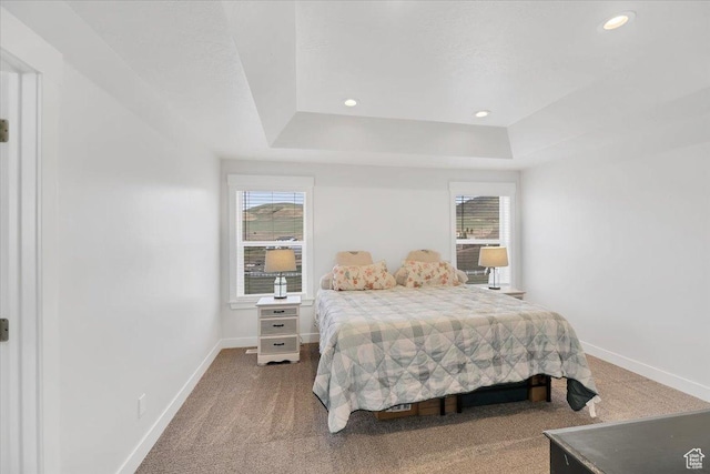 bedroom featuring a raised ceiling, carpet flooring, baseboards, and recessed lighting