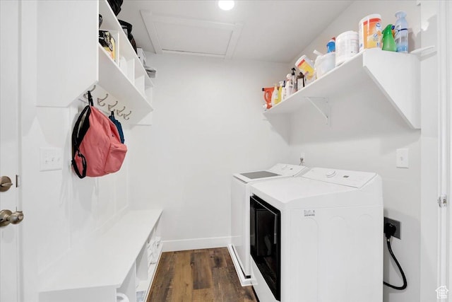 laundry room with washer and clothes dryer, dark wood-type flooring, laundry area, and baseboards