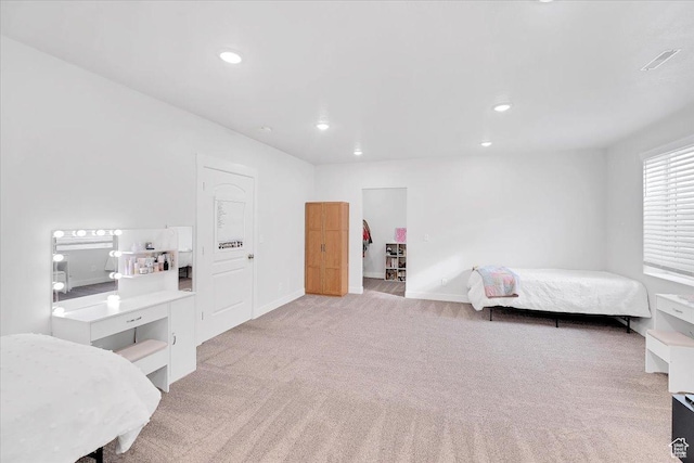 bedroom featuring light carpet, recessed lighting, and baseboards