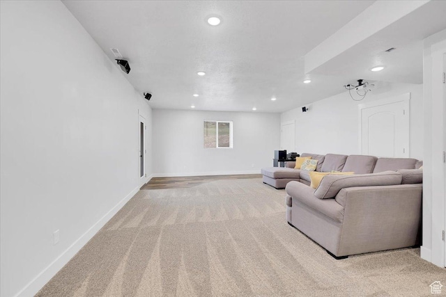 living area featuring baseboards, recessed lighting, and light carpet