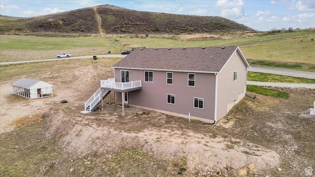 birds eye view of property with a rural view and a mountain view