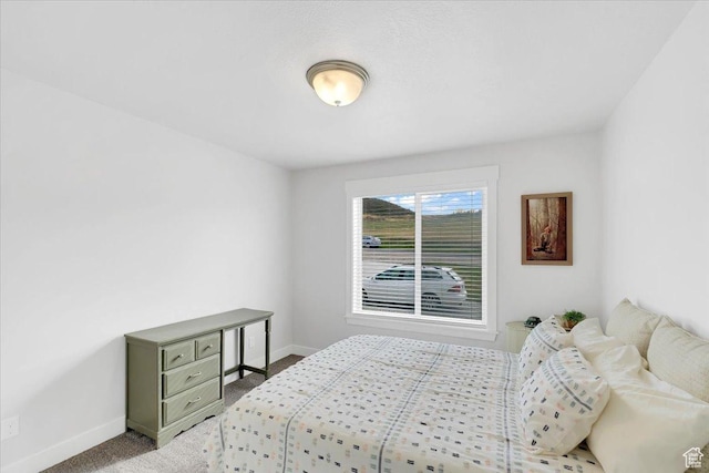 bedroom with light carpet and baseboards