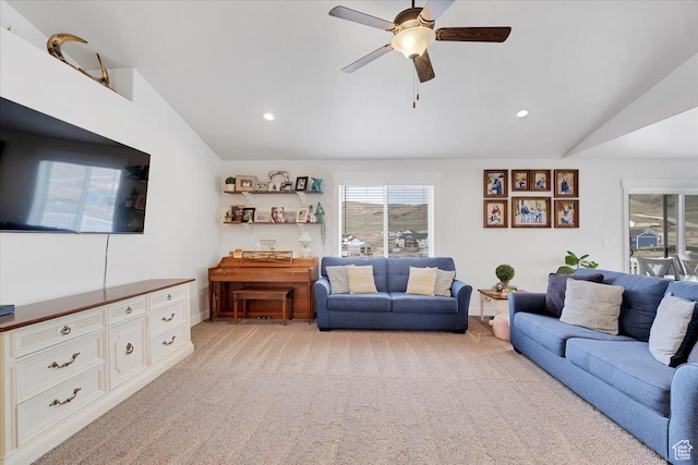living room featuring lofted ceiling, baseboards, recessed lighting, ceiling fan, and light colored carpet