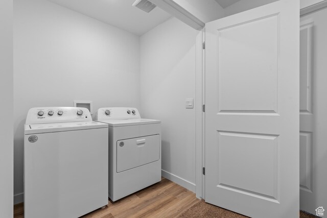 419 S 1130 W Unit 208, American Fork, UT 84003 - laundry area featuring laundry area, light wood-style flooring, visible vents, baseboards, and washing machine and dryer