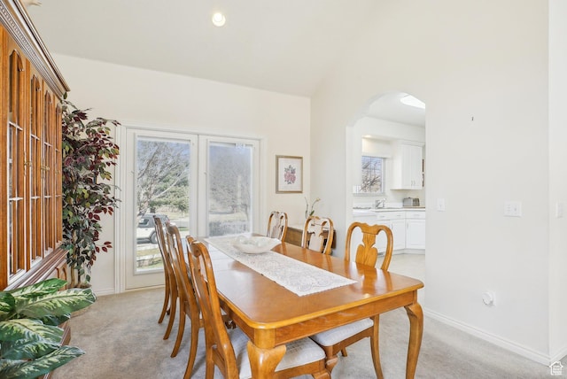 1367 W Settlement Dr, Park City, UT 84098 - dining area featuring arched walkways, light colored carpet, and baseboards