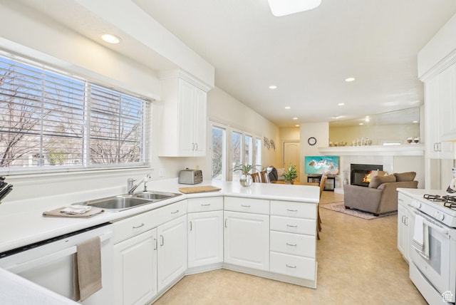 1367 W Settlement Dr, Park City, UT 84098 - kitchen with white cabinets, white appliances, a glass covered fireplace, and recessed lighting