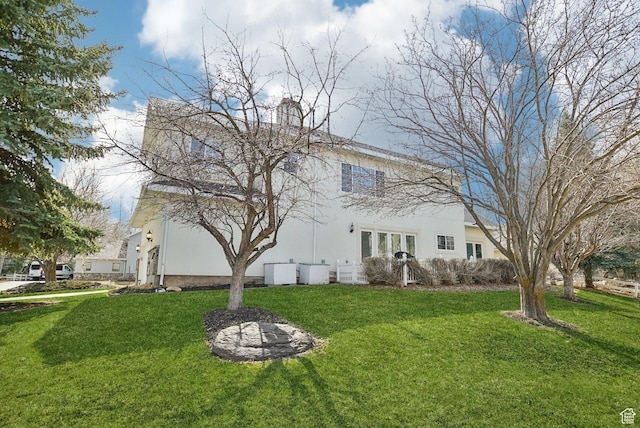 1367 W Settlement Dr, Park City, UT 84098 - back of house with stucco siding and a lawn