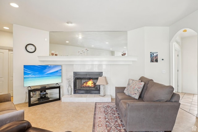 1367 W Settlement Dr, Park City, UT 84098 - tiled living area with arched walkways, a tile fireplace, vaulted ceiling, and recessed lighting