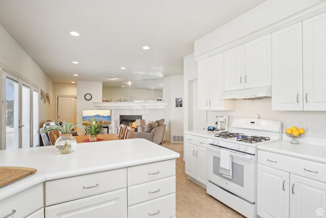 1367 W Settlement Dr, Park City, UT 84098 - kitchen with white cabinets, light countertops, white range with gas stovetop, and under cabinet range hood