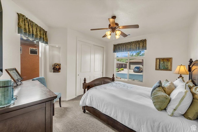 bedroom featuring baseboards, a closet, a ceiling fan, and light colored carpet