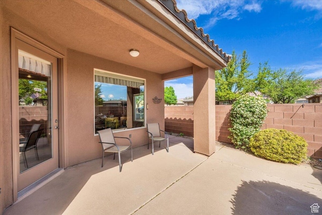 view of patio / terrace featuring fence