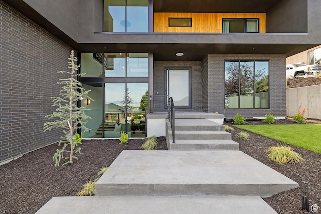 entrance to property featuring brick siding
