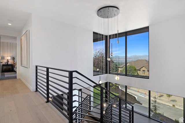 staircase featuring baseboards and wood finished floors