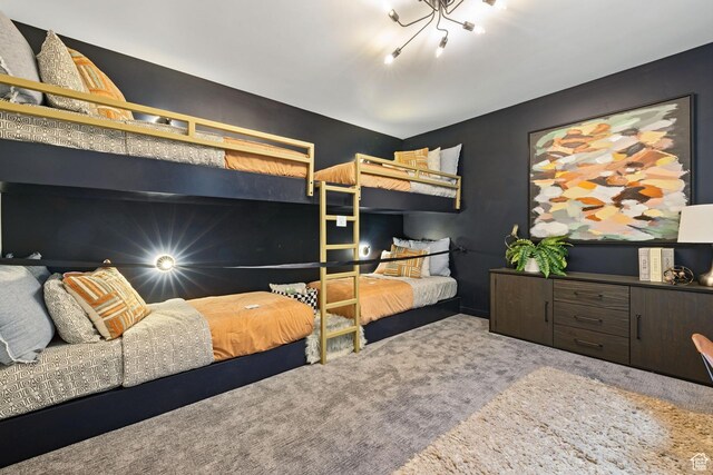 bedroom featuring an inviting chandelier and carpet