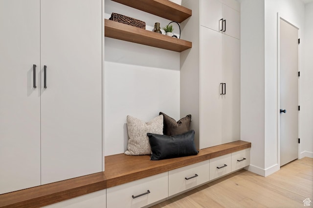 mudroom featuring baseboards and light wood finished floors