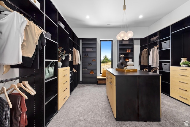 walk in closet featuring light carpet