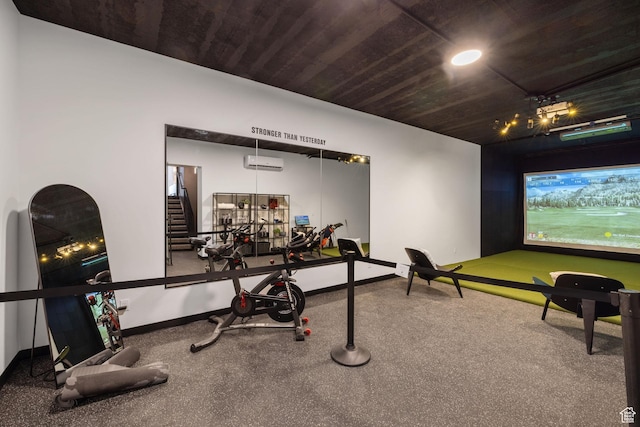 exercise area featuring a wall mounted AC, golf simulator, baseboards, and wood ceiling